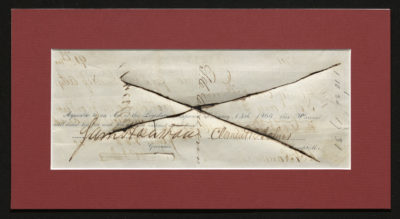 Backside shows signatures and an X crossing the document where ink bled through and cut the paper