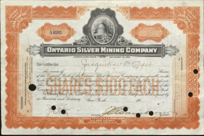 Certificate with black and orange ink shows intricate borders, lettering, signatures, a cancel stamp, and a vignette of a beehive and flowers