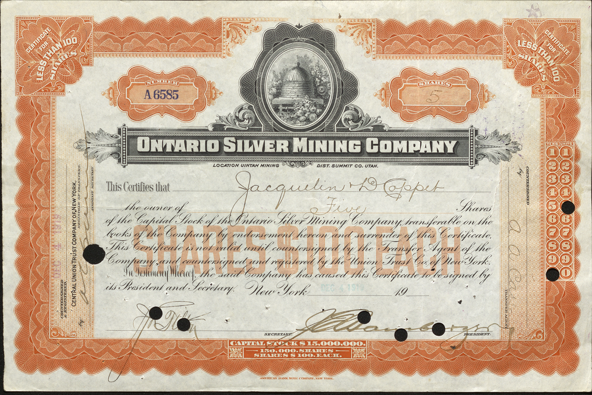 Certificate with black and orange ink shows intricate borders, lettering, signatures, a cancel stamp, and a vignette of a beehive and flowers