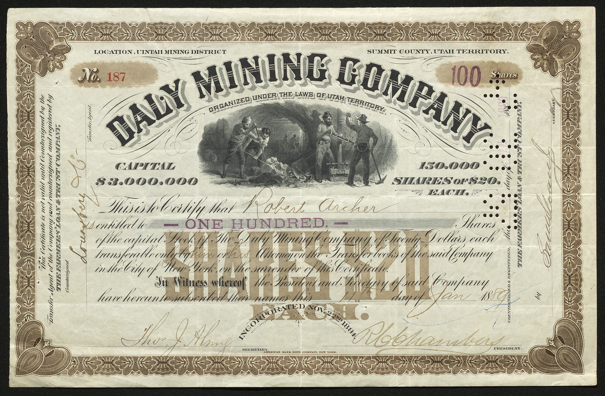 Certificate with black and brown ink shows intricate lettering, signatures, a punched-out date stamp, and a vignette with miners and mining carts