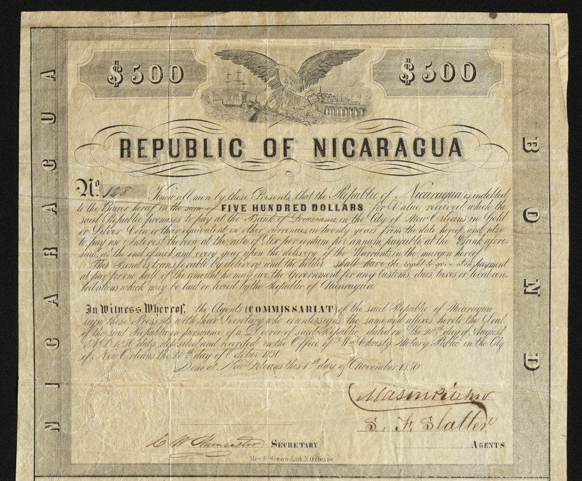Certificate with black ink shows intricate borders, lettering, signatures, and vignettes of an eagle, ship, city, and train